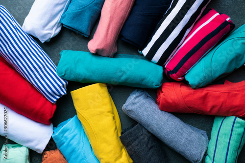 close up of rolled colorful clothes on black background