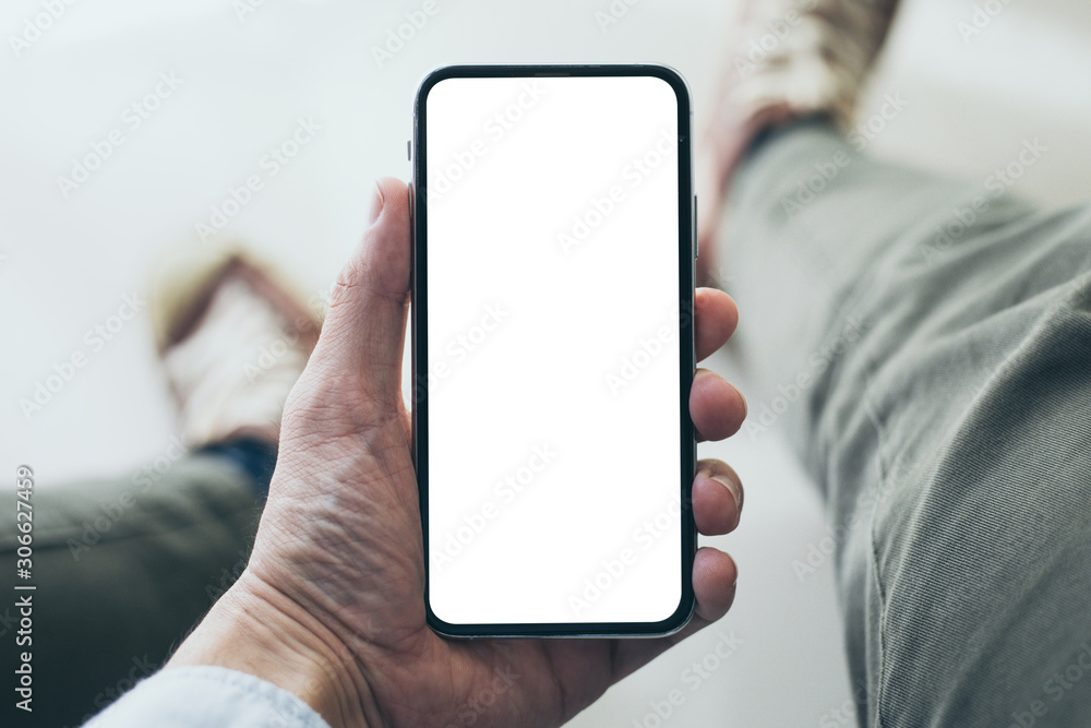 Mockup image blank white screen cell phone.men hand holding texting using mobile  background empty space for advertise text.people contact marketing business and technology 