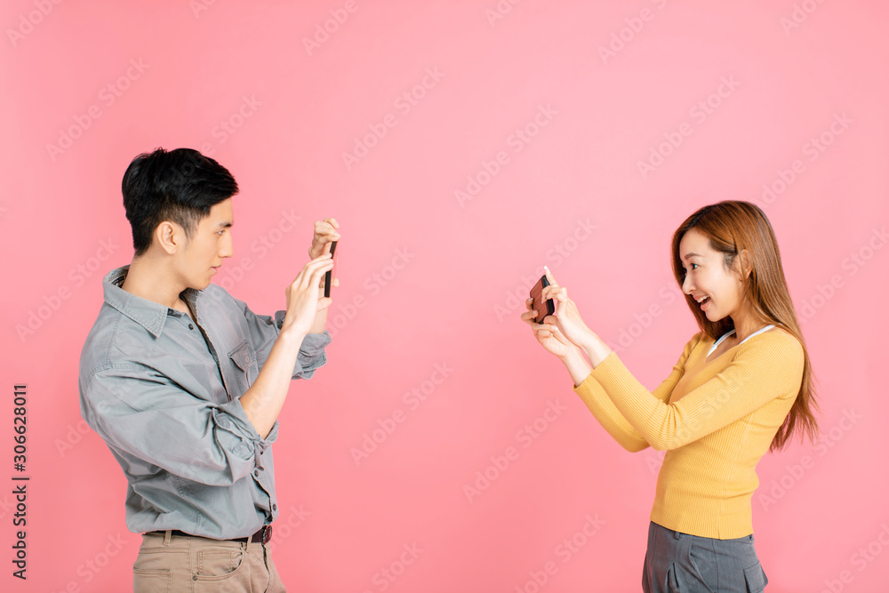 Cheerful young couple taking photo with the smart phone Cheerful young couple taking photo with the smart phone