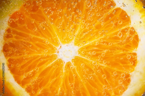 Macro of ripe orange, small depth of field. Blurred fruit background