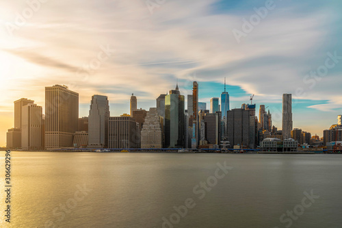 New york Cityscape with Brooklyn Bridge over the east river at the evening time, USA downtown skyline, United states of America, Architecture and building with tourist concept © THANANIT