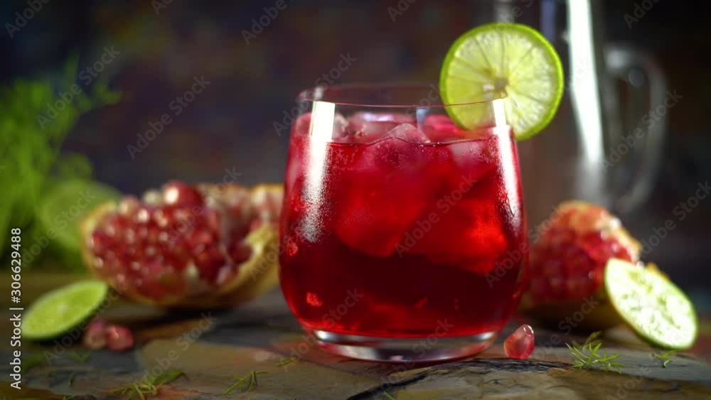 Still life photography of Pomegranate juice lemon soda with pomegranates seeds on table. Shooting at studio,low key toned image, Selective focus and free space for text. Healthy fruits drink concept. Still life photography of Pomegranate juice lemon soda with pomegranates seeds on table. Shooting at studio,low key toned image, Selective focus and free space for text. Healthy fruits drink concept.