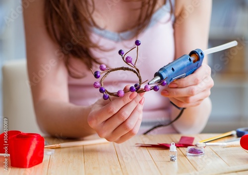 Woman making jewelry at home