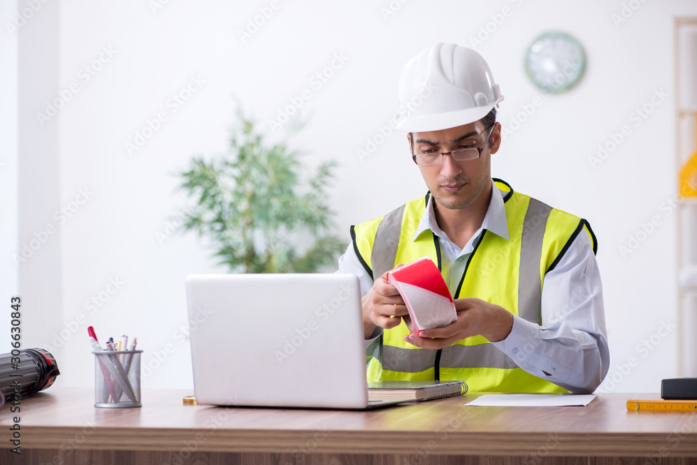 Young male architect working in the office Young male architect working in the office