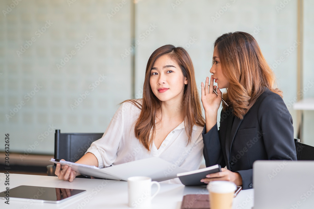 Two girls are gossiping, colleagues are reporting. Two girls are gossiping, colleagues are reporting.