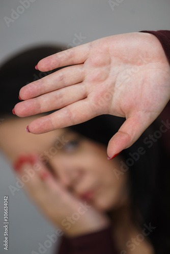 Scared woman with stop hand gesture