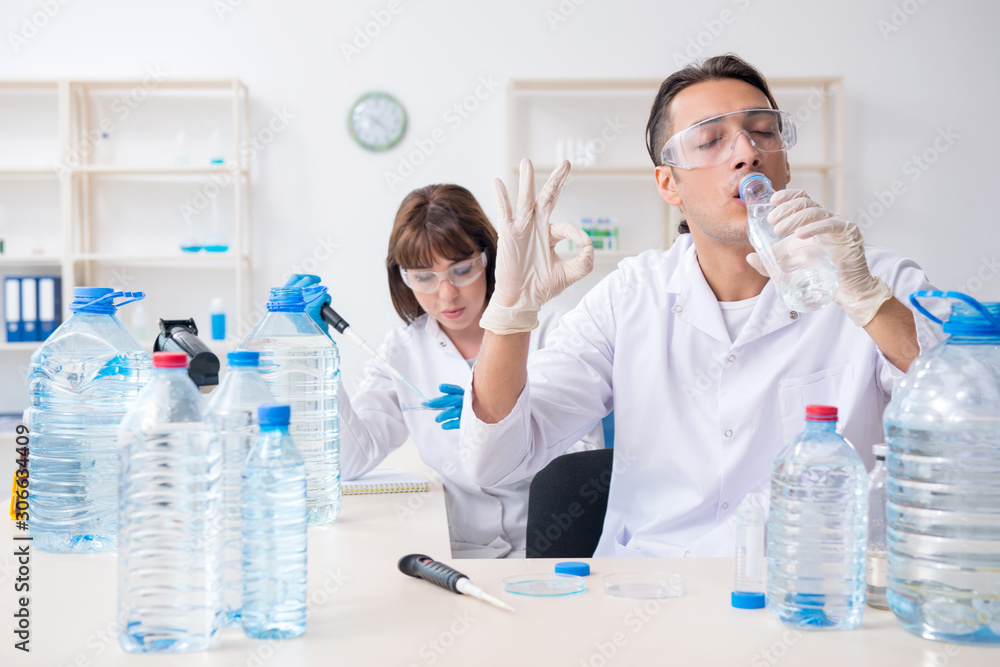 Two chemists working in the lab Two chemists working in the lab