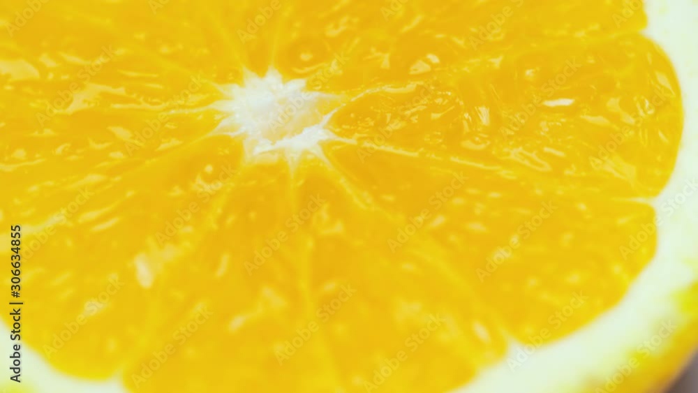 Extreme close up of spinning juicy slice of orange Extreme close up of spinning juicy slice of orange