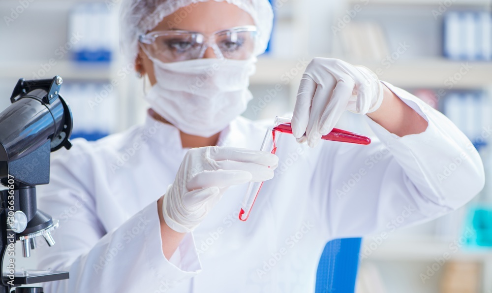 Female scientist researcher conducting an experiment in a labora Female scientist researcher conducting an experiment in a labora