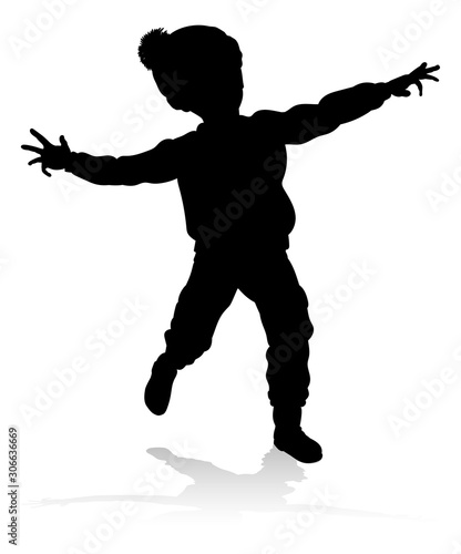 A child in silhouette playi...