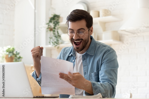 Canvastavla Excited man reading postal mail letter overjoyed by good news
