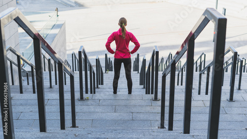 фотографія Young adult sporty girl  looking at stairs, preparing to training