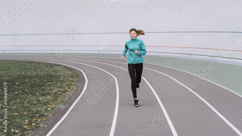 Young adult sporty woman running on sport training in city