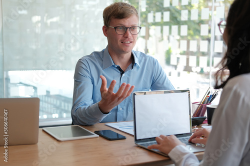 business people discussing on performance revenue in meeting. businessman working with businesswoman.