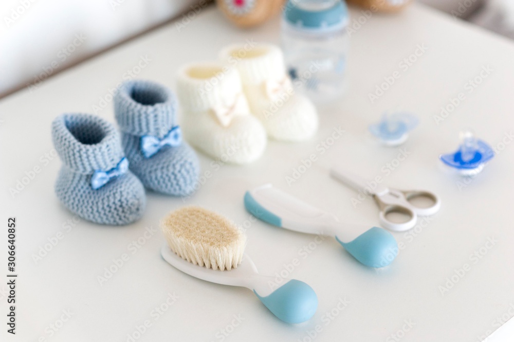 knitted baby shoes with milk bottle, scissors, pacifier and baby comb knitted baby shoes with milk bottle, scissors, pacifier and baby comb