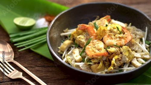 Thai traditional food: Still life of Pad Thai, stired noodles with shrimps, egg served with lime,vegetable. Pad Thai is popular on street food, Thailand, Clean food good taste concept. photo