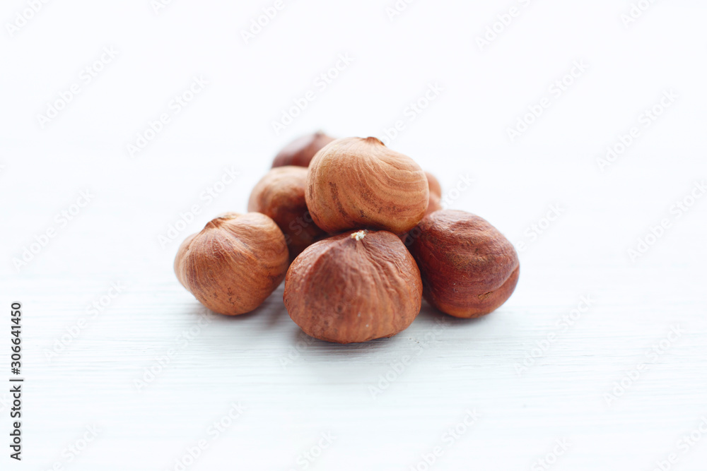 Hazelnuts on white wooden table with clipping path Hazelnuts on white wooden table with clipping path