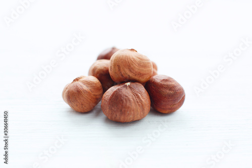 Hazelnuts on white wooden table with clipping path