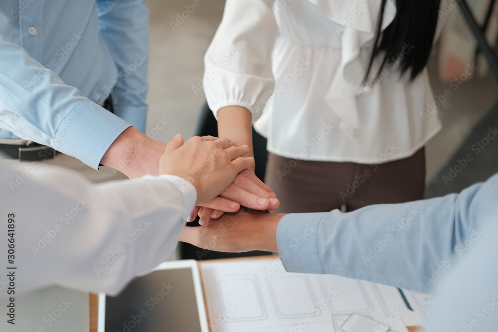 businessman businesswoman joining united hand, business team touching hands together. unity teamwork partnership concept. businessman businesswoman joining united hand, business team touching hands together. unity teamwork partnership concept.