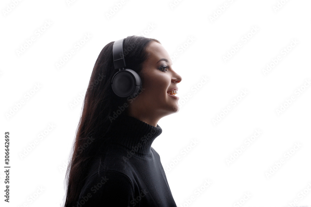 Happy beautiful woman in headphones listening music. White background. Free space for text.