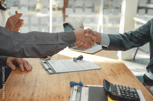 couple customer shaking hands with insurance mortgage broker lawyer realtor. client handshaking financial advisor bank worker