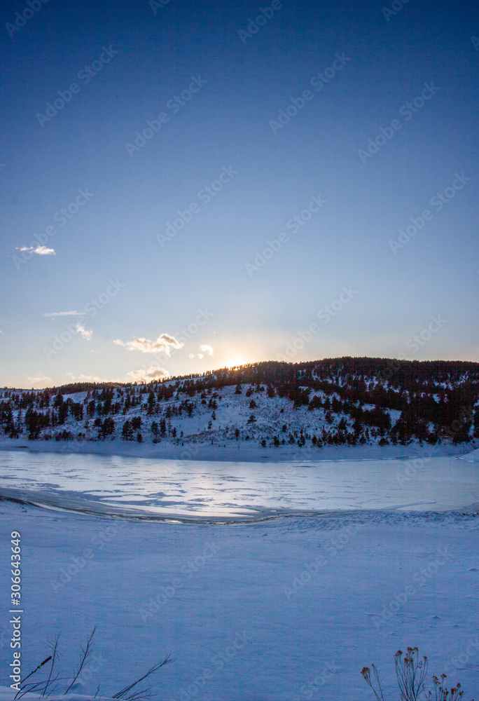 Frozen lake in the foothills of the Colorado Rockies just before sunset Frozen lake in the foothills of the Colorado Rockies just before sunset