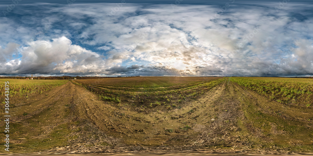full seamless spherical hdri panorama 360 degrees angle view among fields in autumn sunny evening with awesome clouds in equirectangular projection with zenith and nadir, ready for VR virtual reality