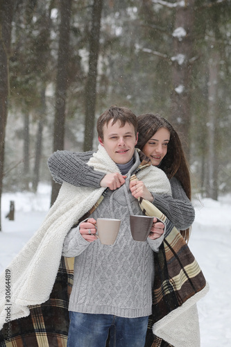 pair of lovers on a date winter afternoon in a snow blizzard