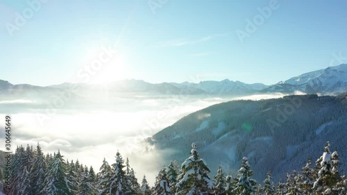 A rise over trees on a sunny day in Zell am See, Austria in winter. photo