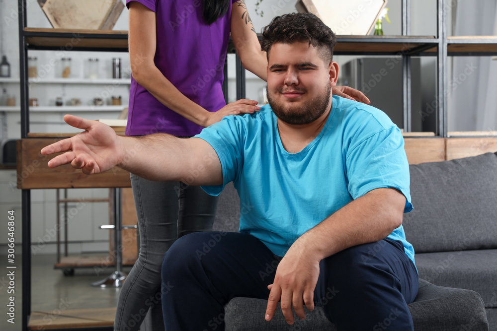 Woman comforting her depressed overweight friend at home Woman comforting her depressed overweight friend at home