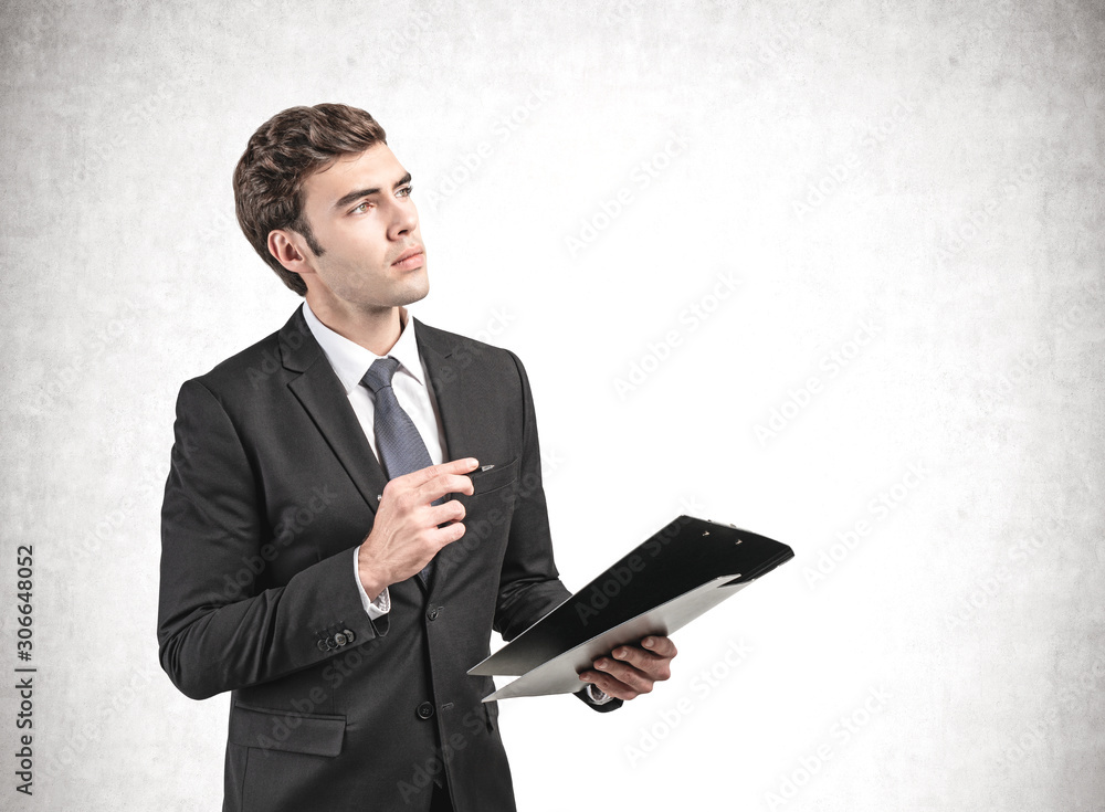 Thoughtful businessman with clipboard, mock up Thoughtful businessman with clipboard, mock up