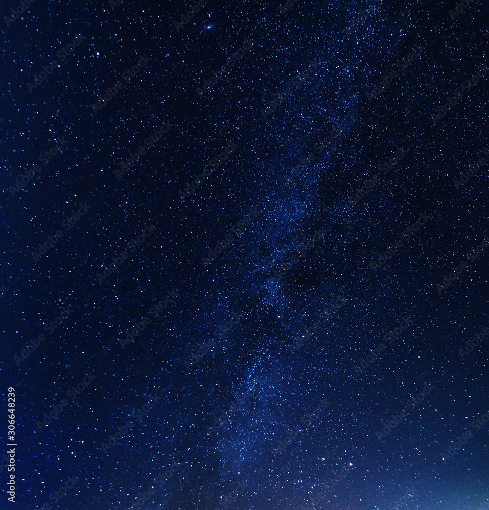 Obraz premium A magical starry night on the river bank with a milky way in the sky and falling stars in the winter.