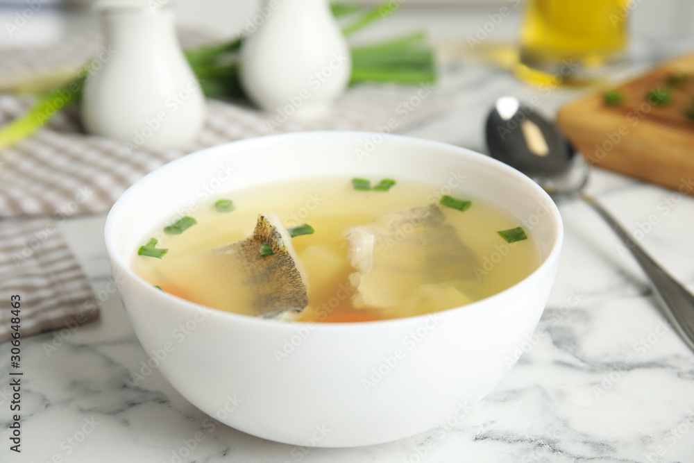 Delicious fish soup served on marble table, closeup Delicious fish soup served on marble table, closeup