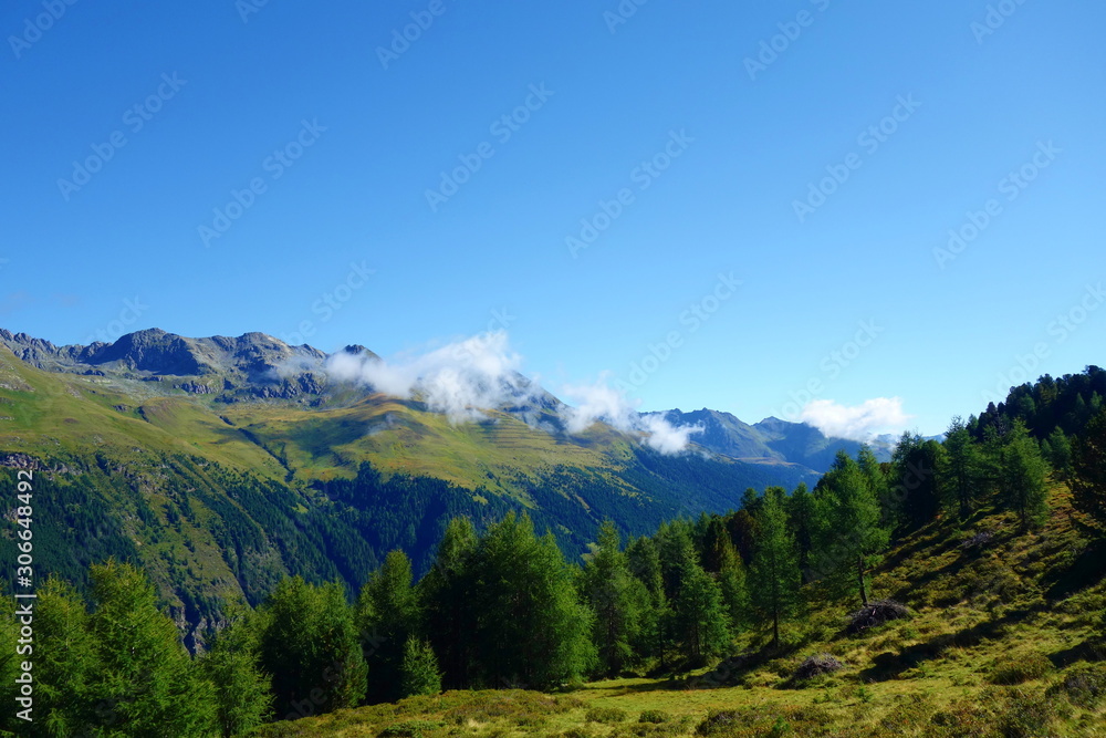 Hiking in Alps on the border of Italy and Austria with panoramic view with the mountains around, Hohe Tauern