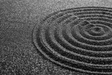 Black sand with beautiful pattern, closeup. Zen concept