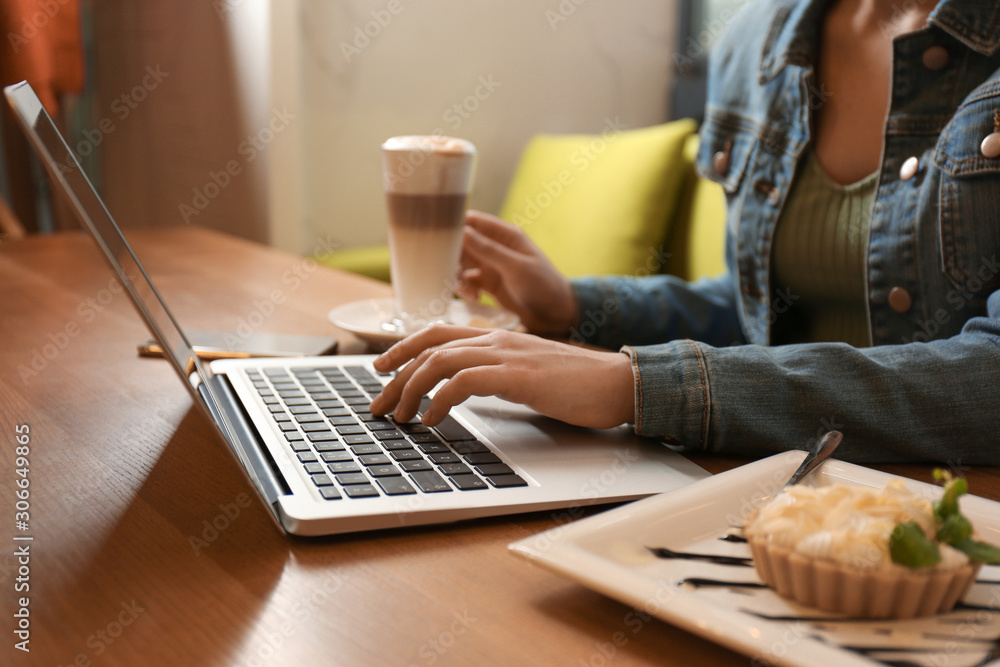 Blogger working with laptop in cafe, closeup Blogger working with laptop in cafe, closeup