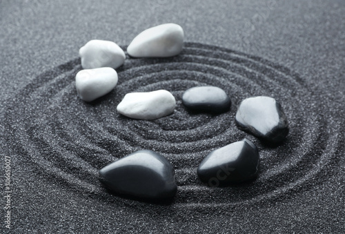 Canvas Print Stones on black sand with beautiful pattern. Zen and harmony