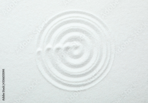 Top view of white sand with pattern. Zen and harmony