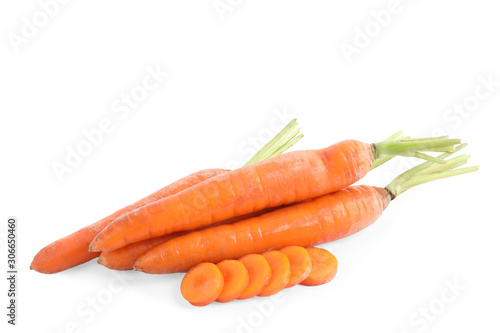 Whole and sliced ripe carrots isolated on white