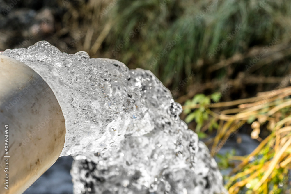 high pressure crystal bluish sweet water flushing out of an agriculture industrial tube waell in fields high pressure crystal bluish sweet water flushing out of an agriculture industrial tube waell in fields