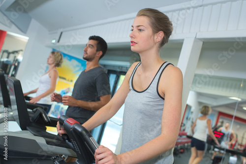 people running in machine treadmill at fitness gym club