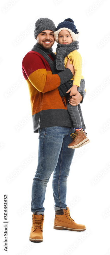 Happy father and son in warm clothes on white background. Winter vacation Happy father and son in warm clothes on white background. Winter vacation