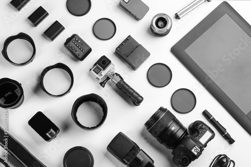 Composition with photographer's equipment and accessories on white background, top view