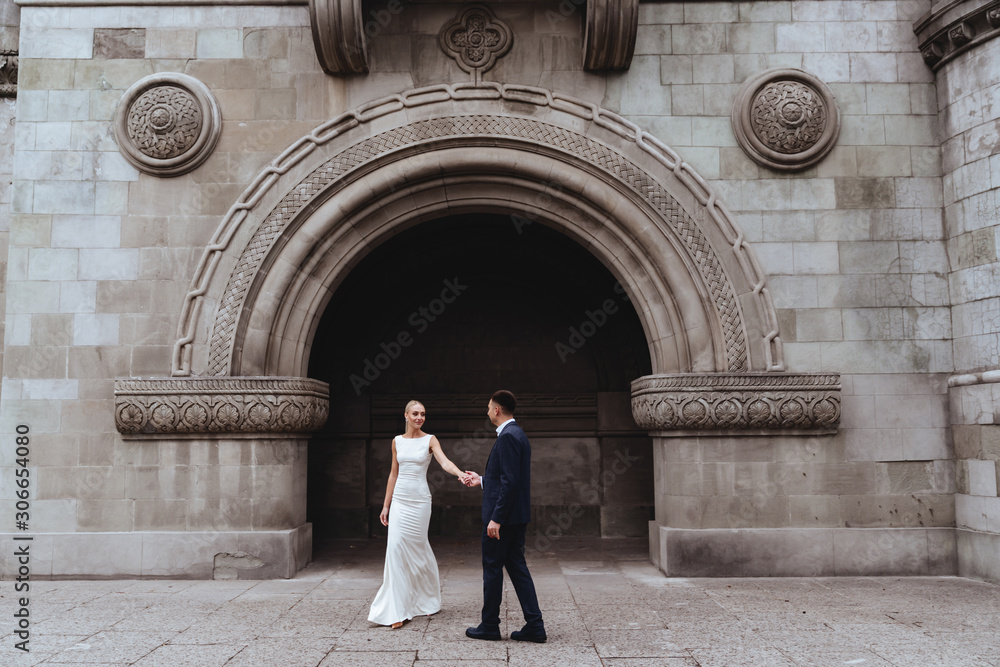 Happy bride and groom near old castle in wedding day