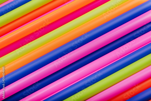 colored tubules for juice and cocktails on pink background. Colorful drink straws. straw, plastic free, reusable plastic drinking background, plastic free. Plastic pollution concept. © Margo Basarab