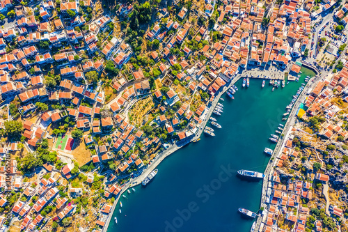 Aerial bird's eye view photo taken by drone of iconic castle of Symi in Ano chora with views to port of Symy island, Dodecanese, Greece photo