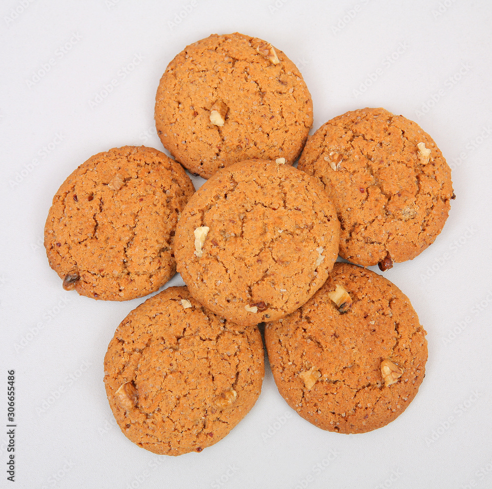 6 oatmeal cookies with crushed walnut on a gray structural background 6 oatmeal cookies with crushed walnut on a gray structural background