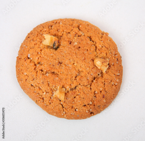 Oatmeal cookies with crushed walnut on a gray texture background