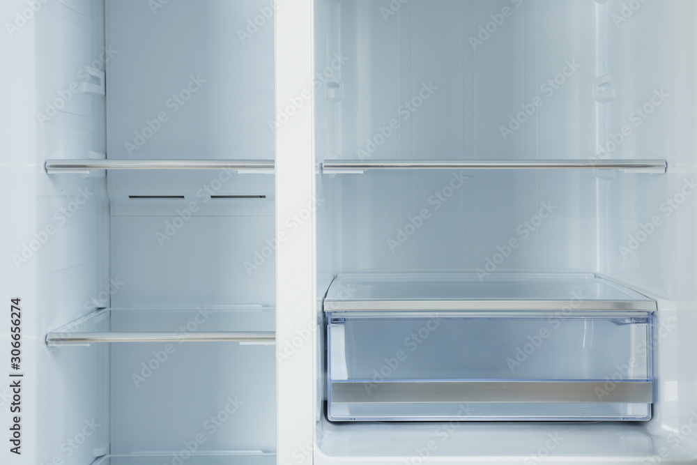 Shelves of empty modern refrigerator, closeup view Shelves of empty modern refrigerator, closeup view