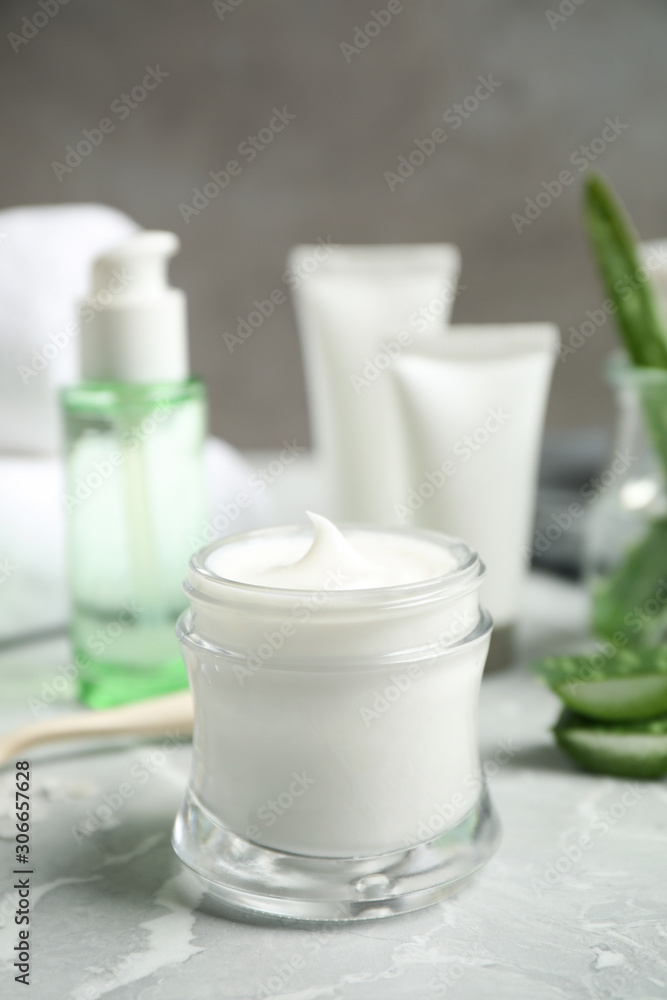 Open jar of aloe cream on grey marble table. Organic cosmetics Open jar of aloe cream on grey marble table. Organic cosmetics